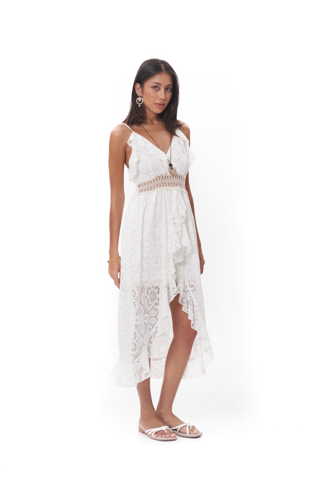 The Lunara Lace Dress features delicate spaghetti straps, a flattering V-neckline, and a softly cinched waist. Designed with intricate lace and an asymmetrical flowing hem, it includes built-in inner shorts beneath the front slit for added comfort and confident coverage. Crafted in a lightweight, breathable fabric, it’s ideal for summer gatherings, resort wear, or sunlit strolls.