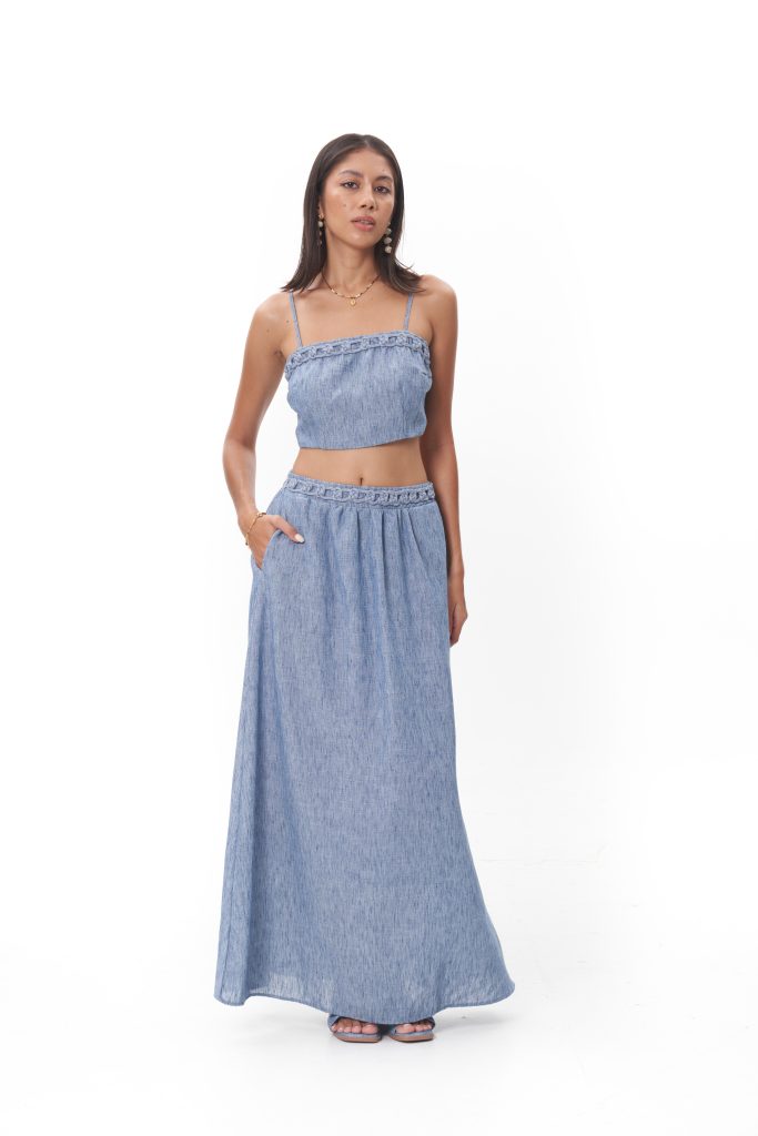 Virelle Top The Virelle Top is a study in soft structure and quiet elegance. Designed with slender straps and a gently smocked bodice, it sits close to the body while maintaining an effortless, airy feel. Subtle textural detailing along the neckline adds a refined bohemian touch, making it an elevated essential that pairs seamlessly with the Virelle Skirt or stands beautifully on its own.