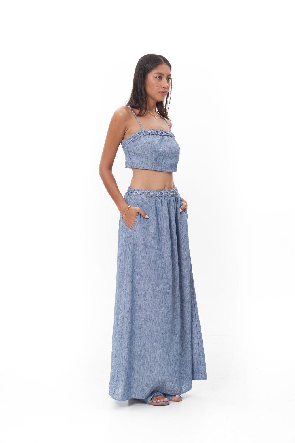Virelle Skirt Fluid and understated, the Virelle Skirt features a softly gathered waist and a graceful, floor-length silhouette. Crafted in a lightweight fabric with natural movement, it drapes effortlessly for a relaxed yet polished finish. Designed to evoke modern bohemian luxury, the Virelle Skirt transitions easily from day to evening, whether worn as a set or styled independently.