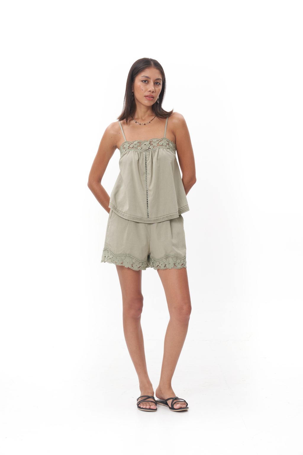 Olivia Lace Camisole Top The Olivia Lace Camisole Top embodies soft femininity with an effortless sense of luxury, crafted from a lightweight, fluid fabric that drapes beautifully against the body. Delicate lace trim frames the neckline, adding a romantic touch, while slender adjustable straps create a graceful, refined silhouette. Designed to feel intimate yet polished, this piece moves seamlessly from relaxed moments to elevated styling, whether worn alone or layered for a sophisticated day-to-night look.