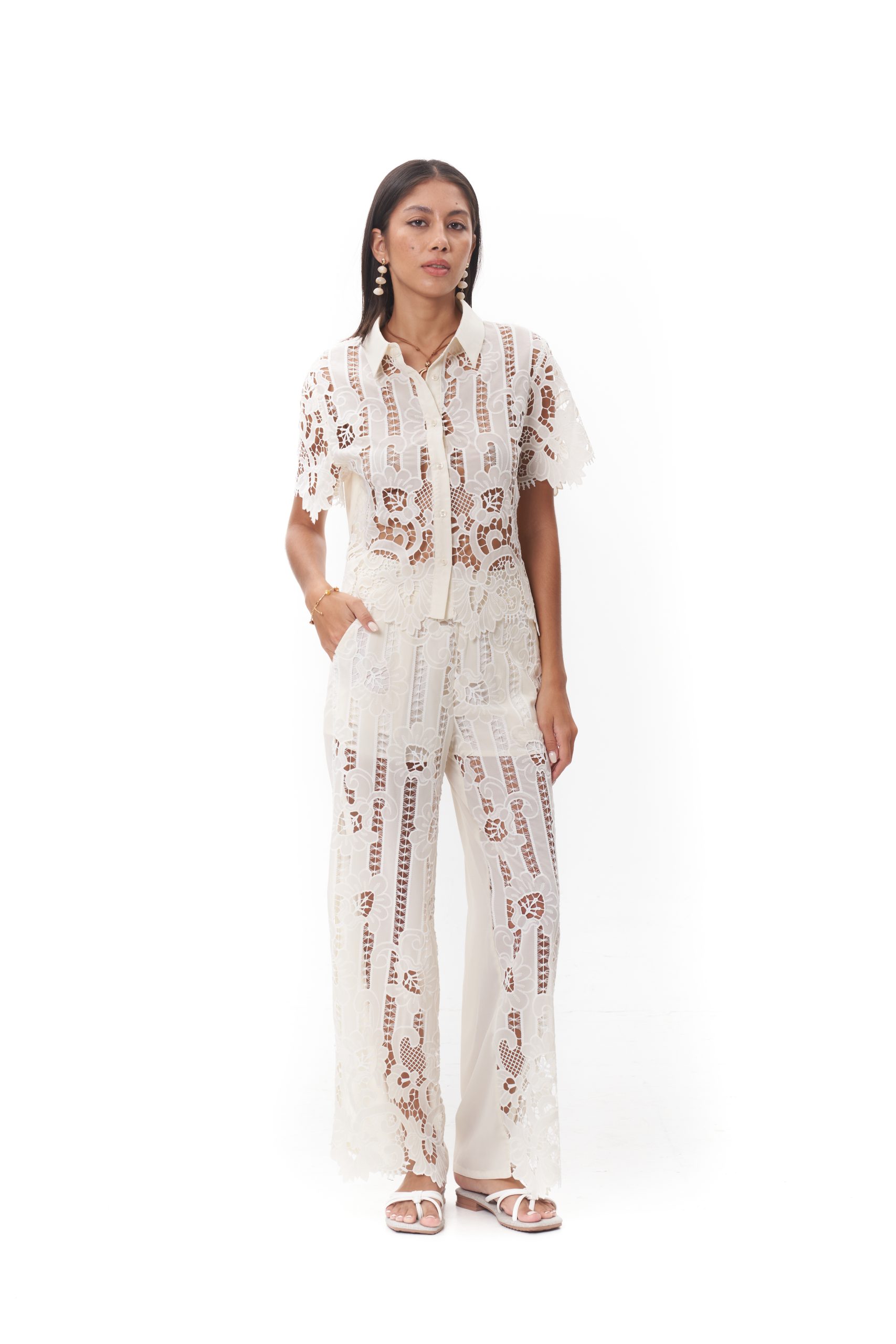 Maribel Lace Top The Maribel Lace Top features a classic collared neckline with a button-front design and short sleeves. Crafted in intricate floral lace with delicate scalloped edges, it offers a refined yet feminine look. Lightweight and breathable, this top is perfect for styling with the matching Maribel Lace Pants or wearing on its own for elevated daytime wear.
