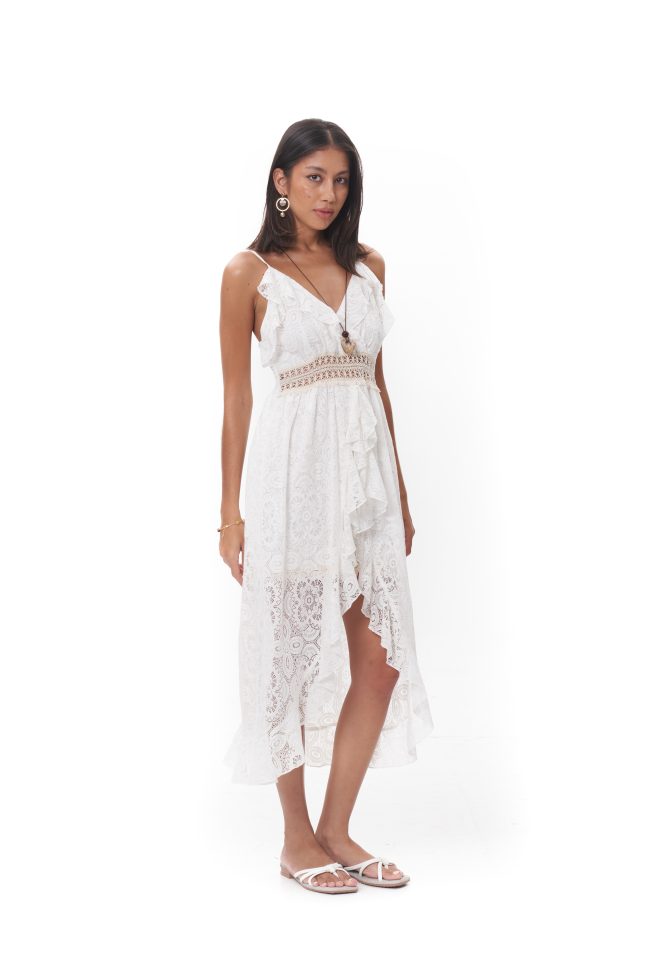 The Lunara Lace Dress features delicate spaghetti straps, a flattering V-neckline, and a softly cinched waist. Designed with intricate lace and an asymmetrical flowing hem, it includes built-in inner shorts beneath the front slit for added comfort and confident coverage. Crafted in a lightweight, breathable fabric, it’s ideal for summer gatherings, resort wear, or sunlit strolls.