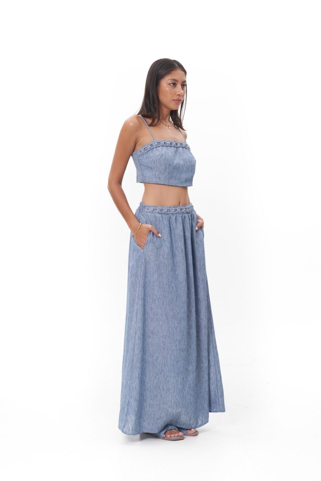 Virelle Skirt Fluid and understated, the Virelle Skirt features a softly gathered waist and a graceful, floor-length silhouette. Crafted in a lightweight fabric with natural movement, it drapes effortlessly for a relaxed yet polished finish. Designed to evoke modern bohemian luxury, the Virelle Skirt transitions easily from day to evening, whether worn as a set or styled independently.