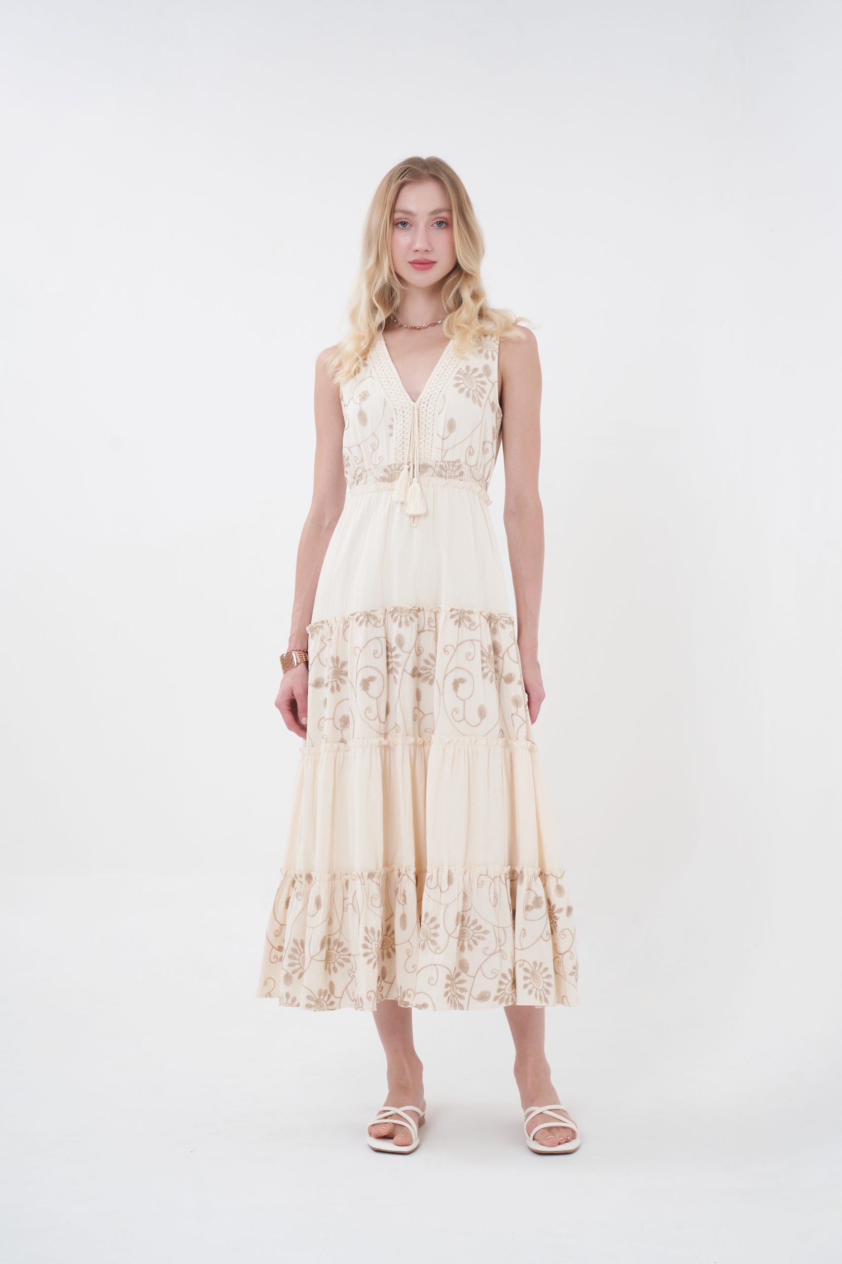The Amelie Maxi Dress offers a romantic charm with a flowing full-length silhouette, featuring a flattering V-neckline, delicate straps, and intricate floral embroidery throughout. Designed with a softly cinched waist and tiered skirt for graceful movement, it provides an elegant, airy feel with a covered back. Perfect for effortless day-to-evening wear.