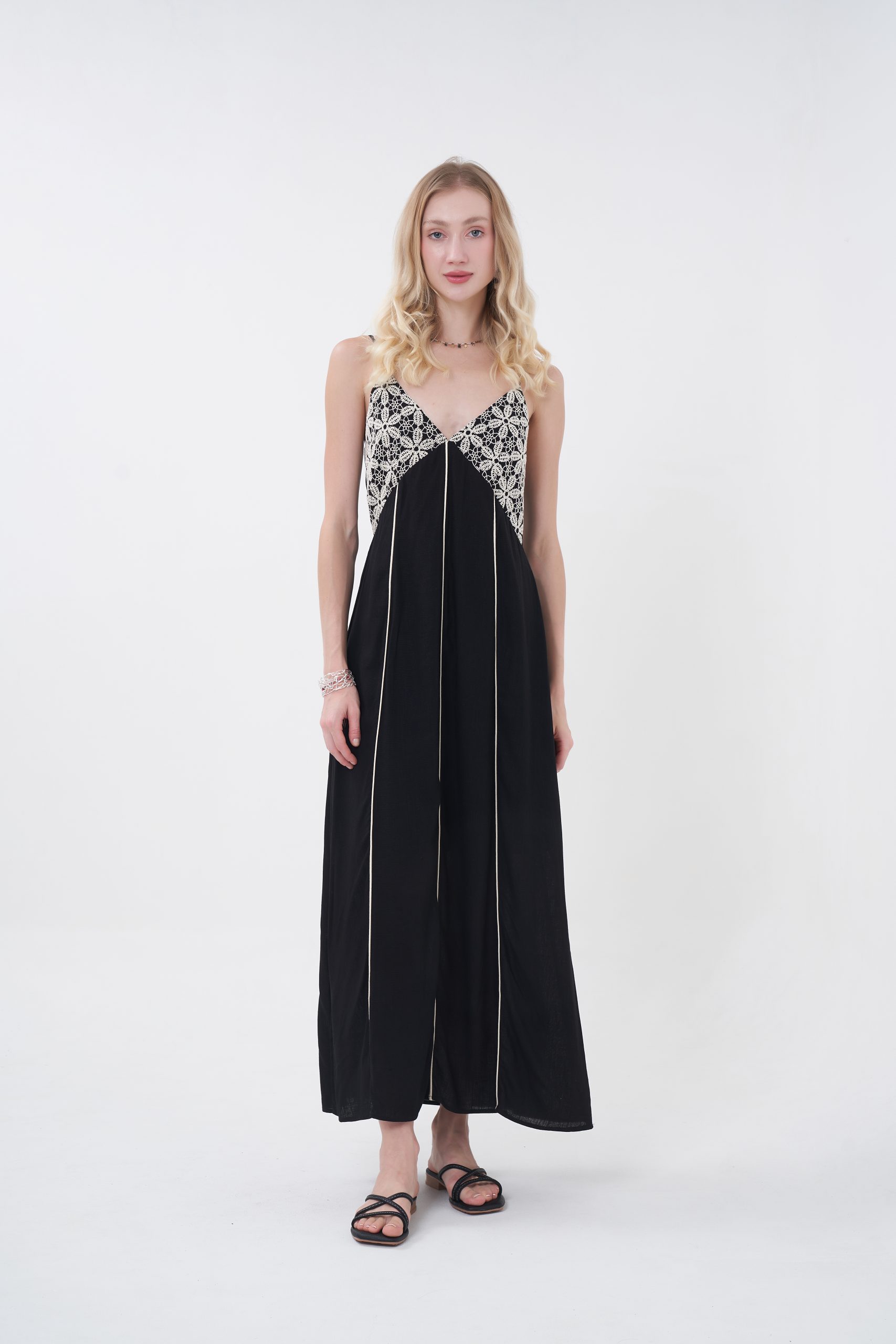 The Fiora Dress is your effortless statement piece for sun-soaked days and breezy nights, blending a relaxed silhouette with delicate artisanal detail. Featuring a flowy maxi cut with a flattering V-neckline, it’s elevated by intricate lace paneling at the bodice that adds a soft, feminine contrast to its lightweight, airy fabric. Subtle vertical accents elongate the frame while adjustable spaghetti straps keep the fit easy and comfortable. Whether styled with sandals for a coastal escape or layered with jewelry for a sunset dinner, Fiora captures that carefree, bohemian spirit with just the right touch of elegance.