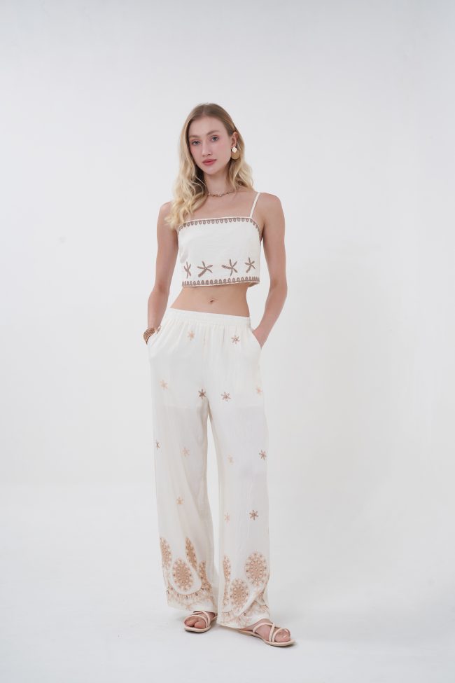 Flowy, breathable, and effortlessly elevated, the Solene Embroidered Pants are designed for movement and ease. The relaxed wide-leg silhouette is complemented by delicate scattered embroidery and a more intricate border at the hem, creating a soft, sun-kissed aesthetic. Finished with an elastic waistband for all-day comfort, they bring a refined bohemian feel to any look.