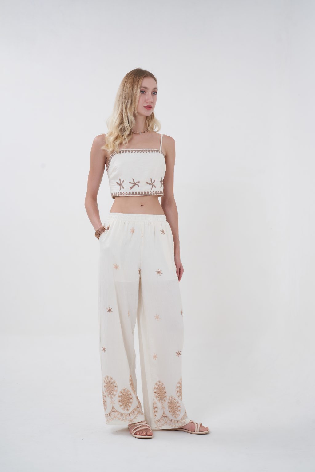 Flowy, breathable, and effortlessly elevated, the Solene Embroidered Pants are designed for movement and ease. The relaxed wide-leg silhouette is complemented by delicate scattered embroidery and a more intricate border at the hem, creating a soft, sun-kissed aesthetic. Finished with an elastic waistband for all-day comfort, they bring a refined bohemian feel to any look.