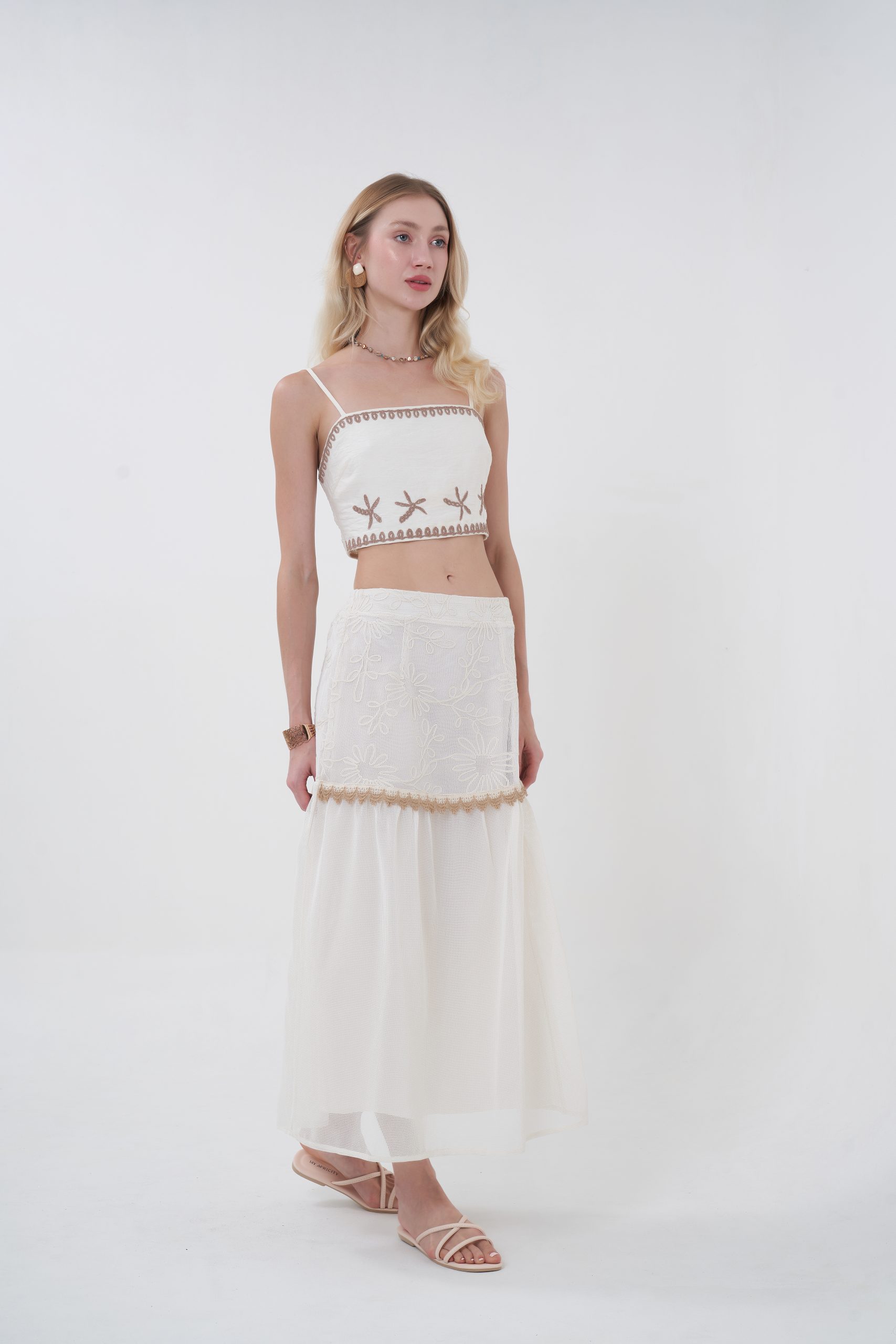 Romantic with a modern edge, the Elowen Textured Midi Skirt features a softly structured silhouette with subtle texture that adds depth without overpowering. The mid-length cut flows naturally with every step, while the delicate trim detail ties it back to the top for a cohesive, elevated set. Light, graceful, and endlessly wearable—this is effortless femininity, redefined.