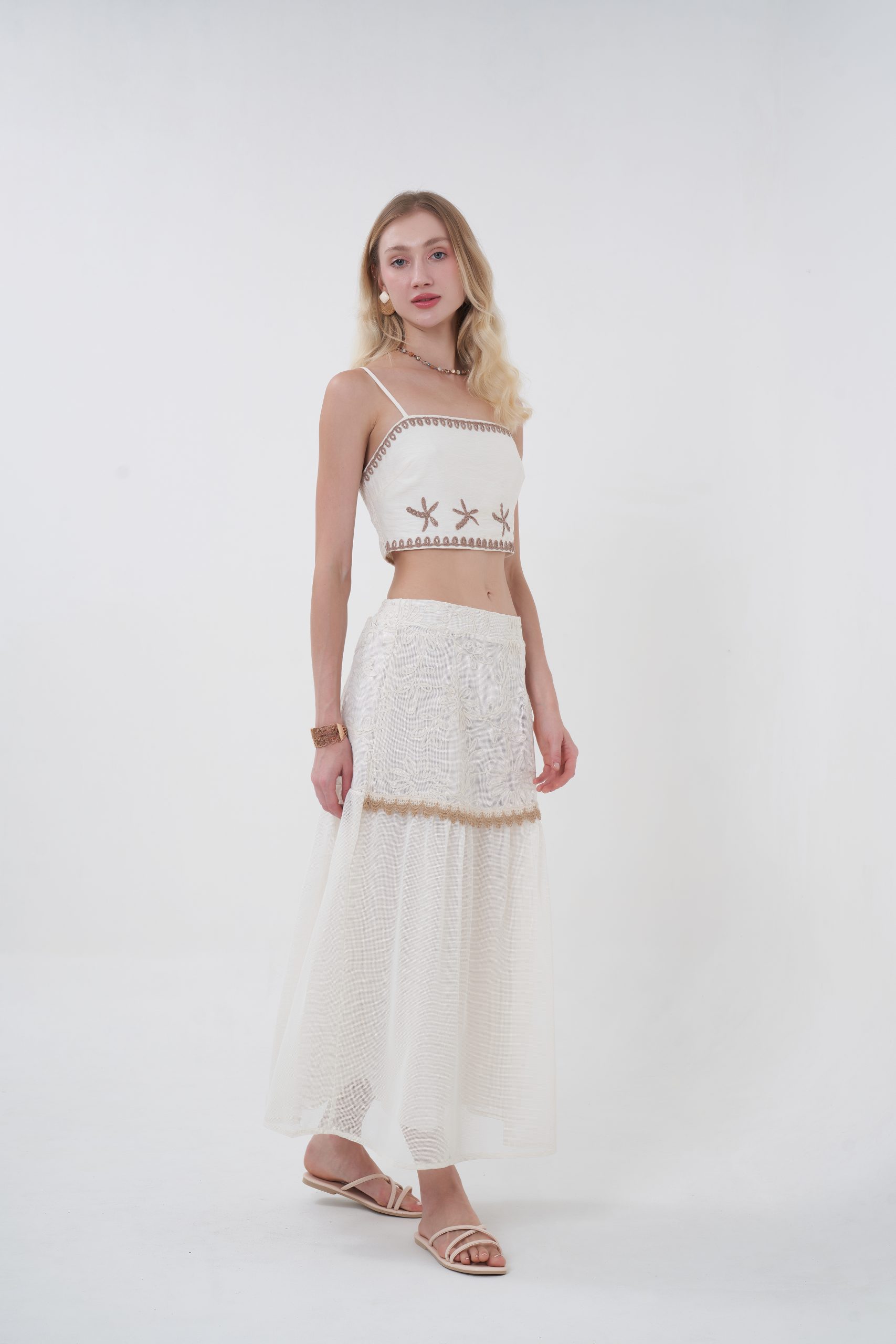 Romantic with a modern edge, the Elowen Textured Midi Skirt features a softly structured silhouette with subtle texture that adds depth without overpowering. The mid-length cut flows naturally with every step, while the delicate trim detail ties it back to the top for a cohesive, elevated set. Light, graceful, and endlessly wearable—this is effortless femininity, redefined.
